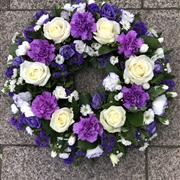 Purple and white funeral wreath